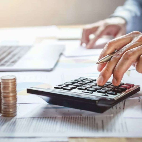 businessman working on desk with using calculator for calculate finance and accounting in office
